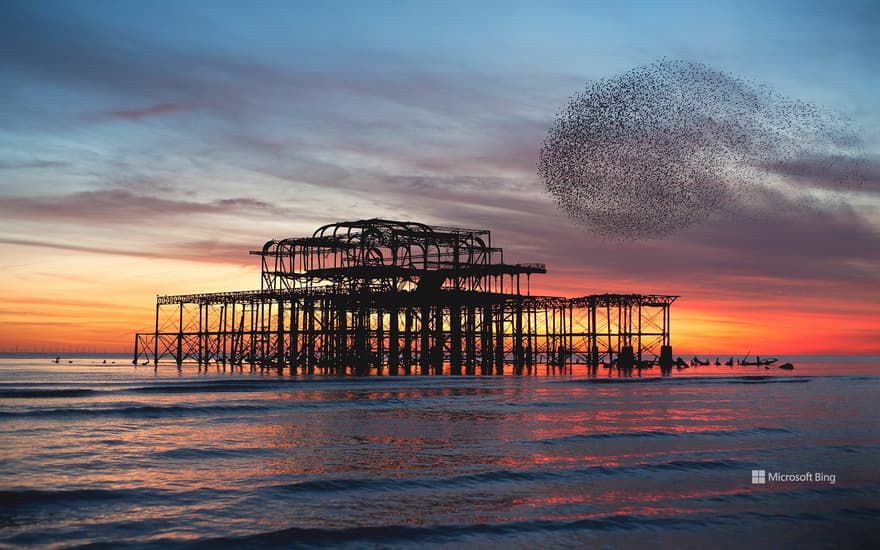 Starling murmuration over the ruins of Brighton's West Pier, England